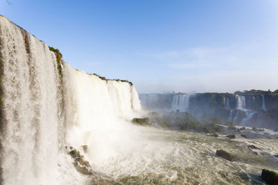 Scenic view of waterfall against sky