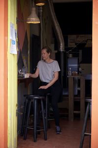 Portrait of smiling young woman sitting on chair