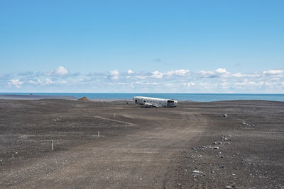 Pathway leading towards plane wreck at black sand beach in solheimasandur