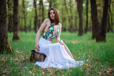 Full length of woman on field in forest