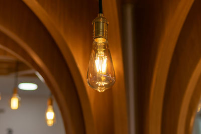 Illuminated light bulbs hanging from ceiling