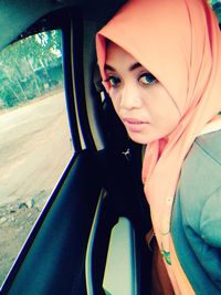 Portrait of beautiful woman in car