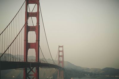 Golden gate bridge in city against sky