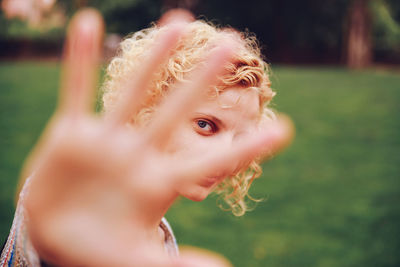 Young woman hiding face with palm