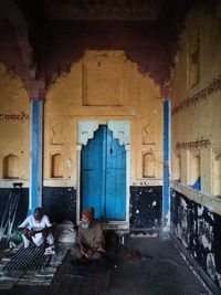 People sitting in abandoned building