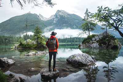 Rear view of man standing in lake