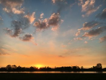 Scenic view of silhouette trees against sky at sunset