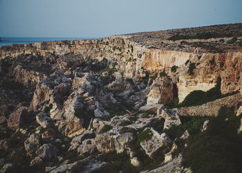 Low angle view of rock formations against sky