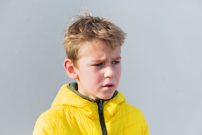 Portrait of boy against yellow background