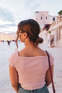 Rear view of woman standing outdoors
