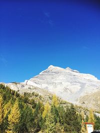 Low angle view of mountain against blue sky