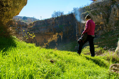 Rear view of woman standing on landscape