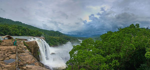 Scenic view of waterfall against sky