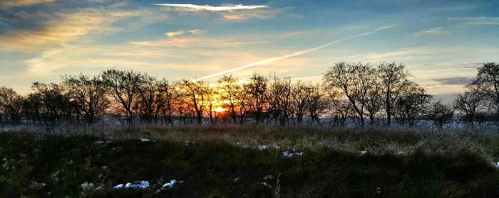 Scenic view of landscape against sky at sunset