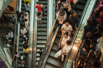 High angle view of people walking on escalator at subway station