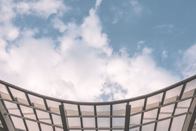 Close-up of glass roof against the sky