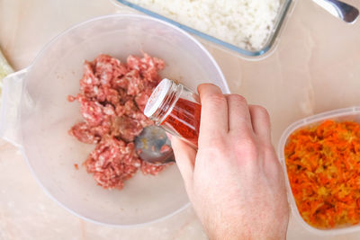 Cropped hand of woman holding food