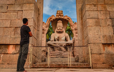 Full length of man at temple against sky