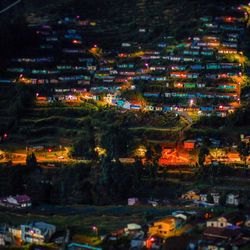 Aerial view of illuminated city at night