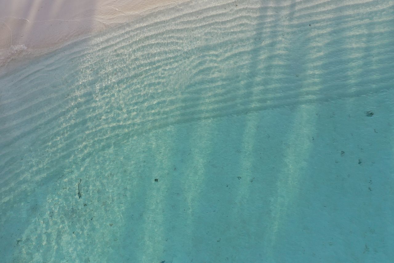 FULL FRAME SHOT OF RIPPLED WATER IN SWIMMING POOL