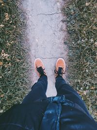 Low section of man standing on walkway