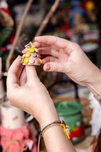 Woman choosing christmas gifts at small craft pottery store. wintertime holidays mood in tropic