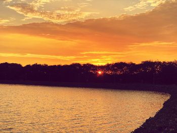 Scenic view of lake against romantic sky at sunset