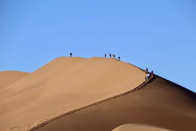 Low angle view of desert against clear sky