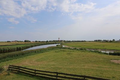 Scenic view of agricultural field against sky