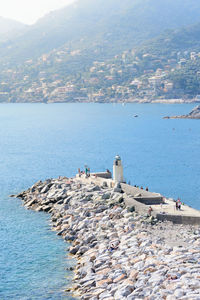 High angle view of buildings by sea against sky