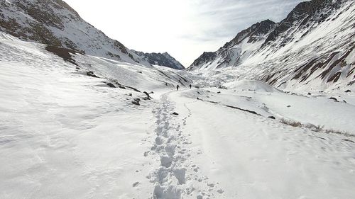 Scenic view of snow covered mountains against sky