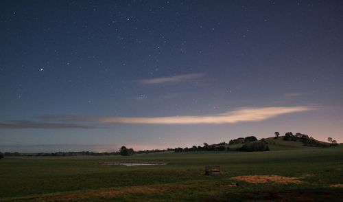 Scenic view of landscape against sky at night