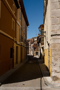 Empty alley amidst buildings in town