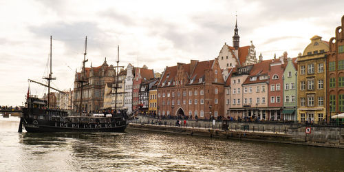 Beautiful old town of gdansk over motlawa river vintage ship pirate caravels sailing on motlawa