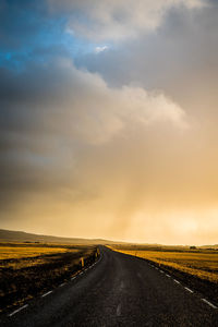 Empty road along countryside landscape