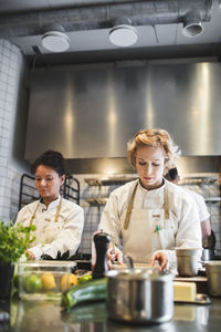 Female chefs preparing food at kitchen counter in restaurant