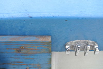 High angle view of metal door on blue wall