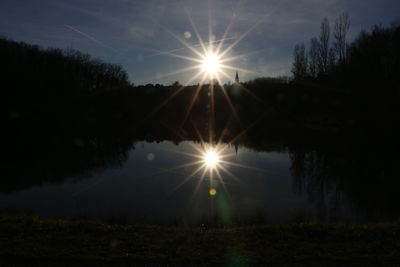 Sun shining over river