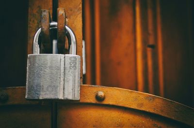 Cropped image of silver padlock on metal gate