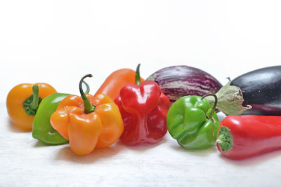 Close-up of bell peppers over white background