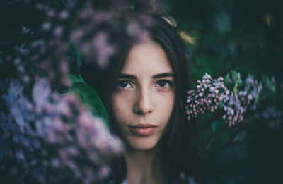 Close-up portrait of beautiful young woman amidst flowers