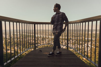 Man standing at observation point against sky