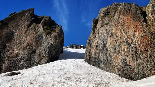 Panoramic view of rock formations in sea against sky