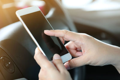 Midsection of man using mobile phone