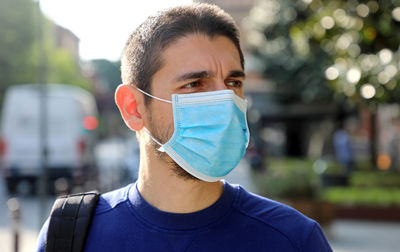 Close-up of man wearing mask while looking away