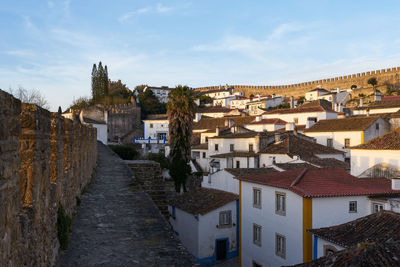 High angle view of buildings in town against sky