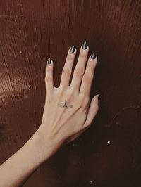 Cropped hand of a woman with a butterfly on it