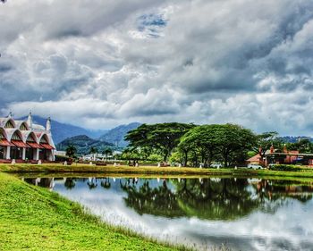 Scenic view of lake by building against sky