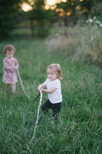 Full length of cute girl playing in field