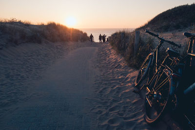 Panoramic view of bicycle on land against sky during sunset